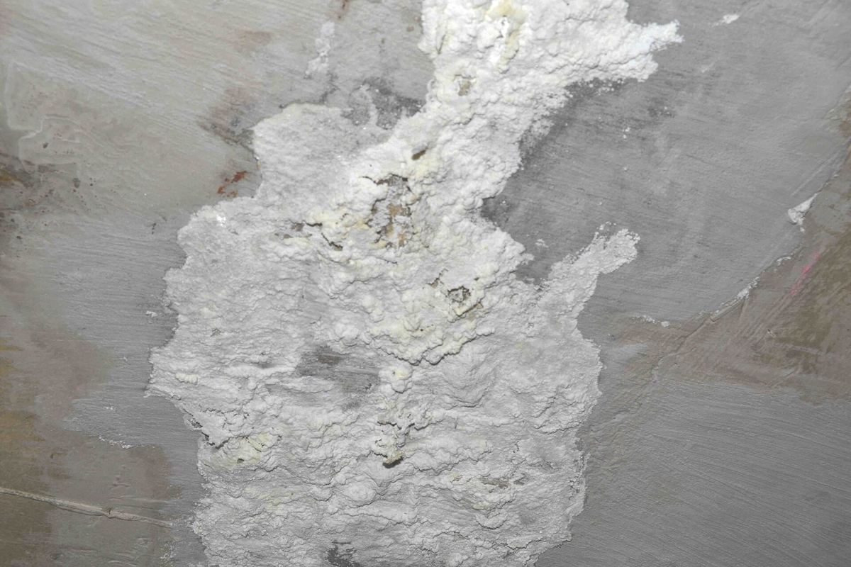 Mineral staining at base of west wall
