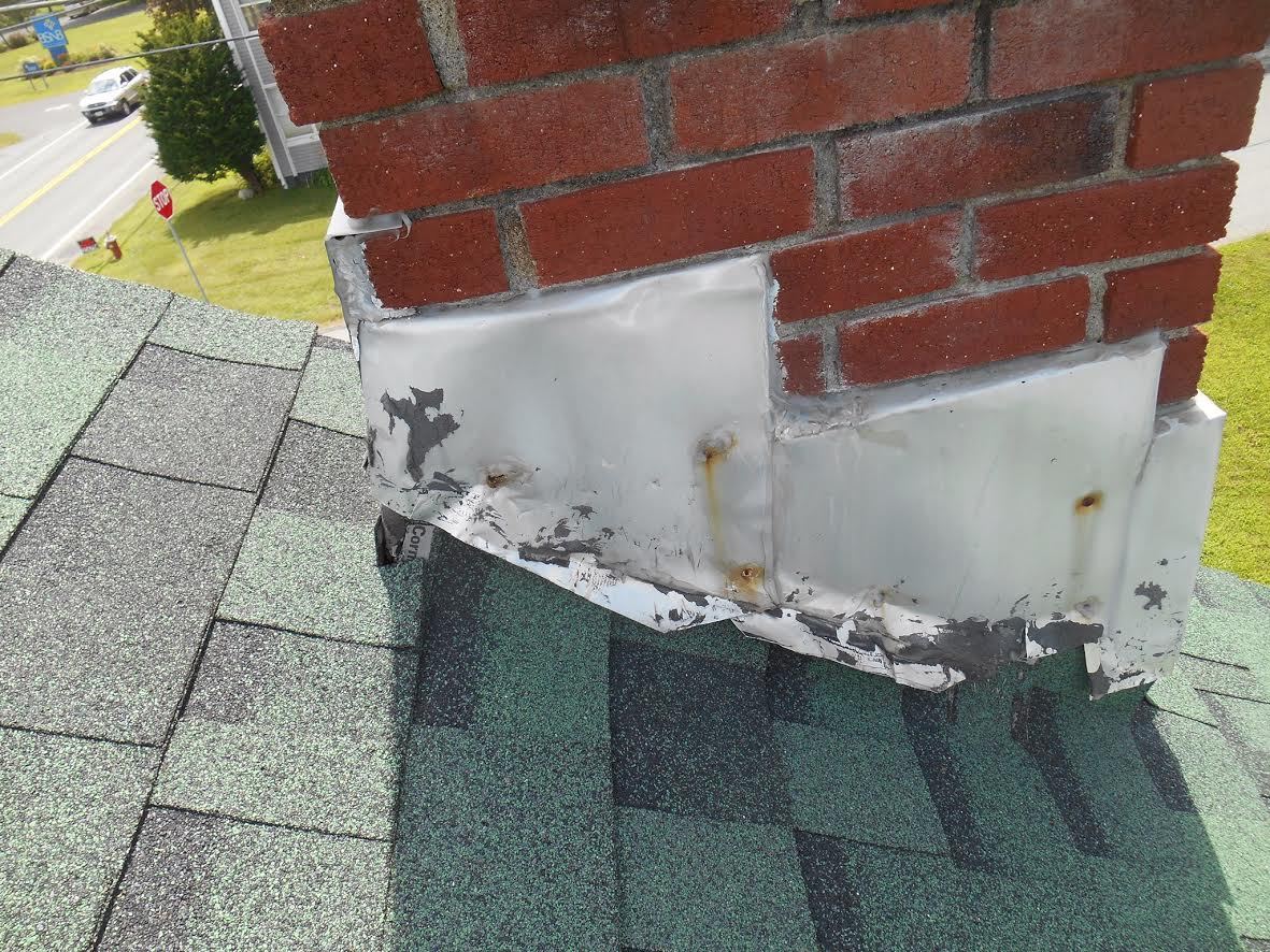 Chimney base flashing, uphill side